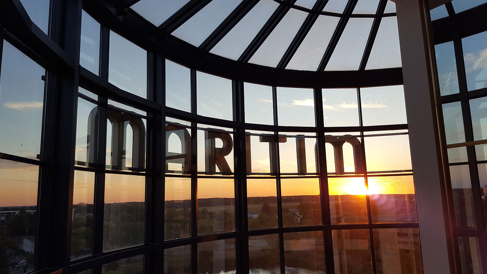 Spektakuläre Aussicht auf den Sonnenuntergang durch die Glasfassade des Maritim Hotel Hannover.